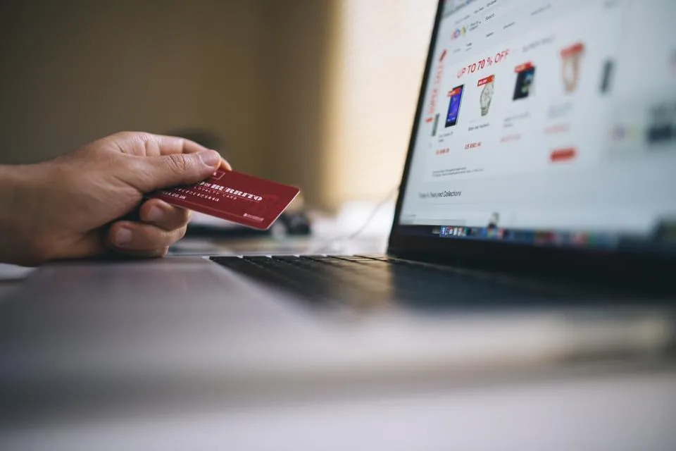 Online store checkout with a payment card and laptop